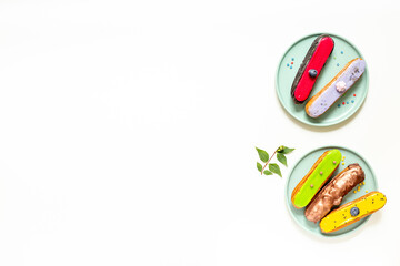 Many various glased eclairs with chocolate and berrie. Sweet food background