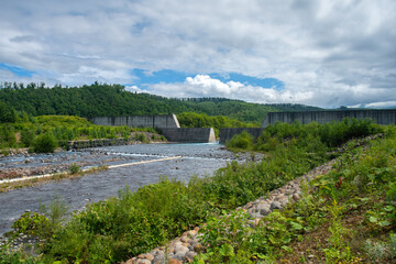 Fototapeta premium Shirahige Dam located during the route to Shirahige Waterfall, Biei, Kamikawa Subprefecture, Hokkaido, Japan