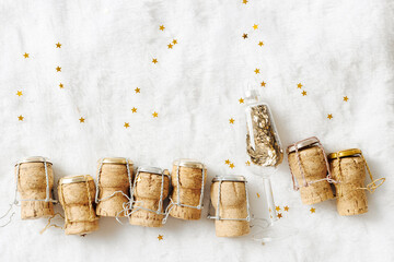 New Year, xmas holiday minimal creative flat lay, row wine bottle corks from sparkling wine with...