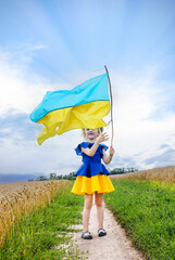 Adorable girl with the Ukrainian national flag