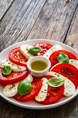 Caprese salad on wooden table
