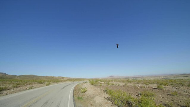 Man flying past road turning around