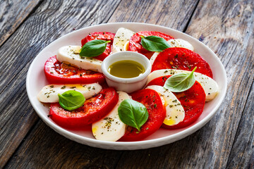Caprese salad on wooden table
