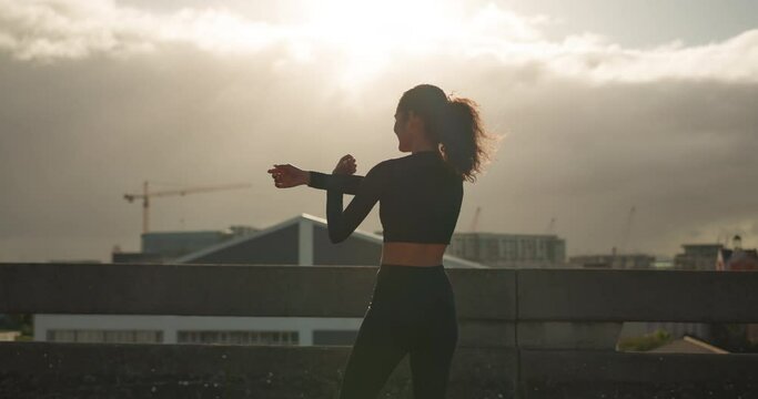 Fitness, city and back of woman celebration for cardio time, running success or workout goals, fist or achievement. Morning wellness, watch check and excited runner, athlete and celebrate on bridge
