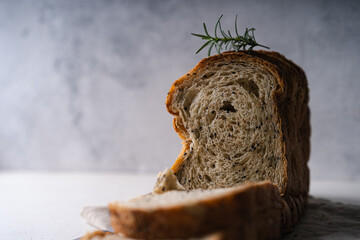 Fresh Sliced Homemade Wholegrain Wheat Bread on white rustic background. Artisan Sourdough