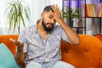 Face palm. Shame on you. Upset Indian man making disrespect gesture, feeling bored, disappointed in...