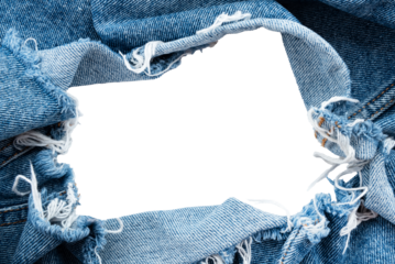 Hole in denim on a white background. Ripped jeans