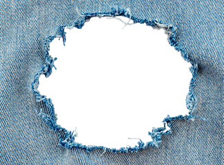 Hole in denim on a white background. Ripped jeans - obrazy, fototapety, plakaty