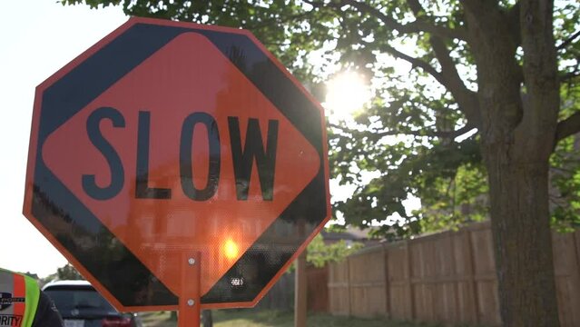 Traffic control with stop slow sign according to construction plan