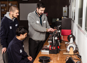 3D scanning and printing training class. Teacher shows how to work on 3D scanner and printer