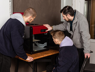 3D scanning and printing training class. Teacher shows how to work on 3D scanner and printer