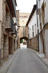 Fototapeta na wymiar Street with an arch in the background made of stone from the medieval period, Spain