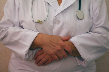 hands of an adult woman doctor with a stethoscope