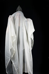 Ghost in a white veil on a black background