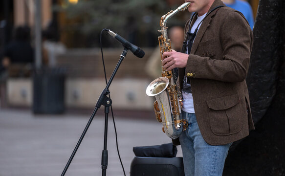 Street musician plays the saxophone