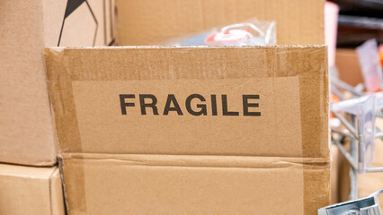 An open brown cardboard box with a FRAGILE label printed on it, opened carton container with a...