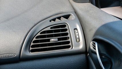 Generic used dusty air conditioner outlet vent in the car, interior object detail closeup, fixing,...