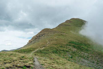 Fototapeta na wymiar Guiding path on a cloudy mountain in Spanish Pyrinees
