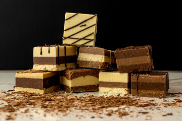stacked bars of Moroccan or cremino style chocolate with grated chocolate