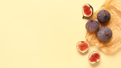  Fresh ripe figs on yellow background with space for text, top view