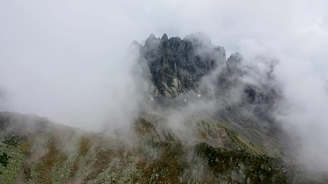 Flying with a drone through the clouds on the magnificent peaks of the Altiparmak Mountains in Rize. High peaks on a wonderful morning, natural landscape. Kackar, Rize.