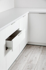 White counters with drawers in light kitchen