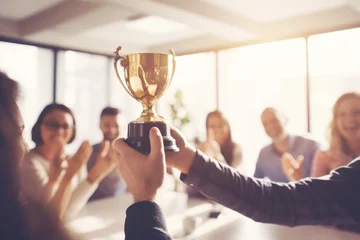 Foto op Plexiglas Business Team Celebrating Gold Trophy. Concept of success and achievement Office Team © fotoyou