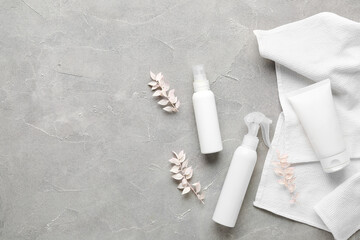 Composition with cosmetic products, dried plants and clean towels on grunge background