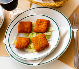 Spanish appetizer San Jacobo, breaded and fried cheese between slices of cooked ham