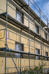 Scaffolding and insulation of a family house.