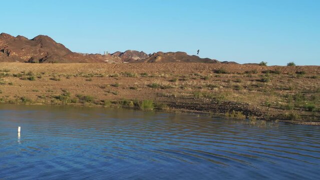 Hoverboard In Distance Flying Over Desert Hill