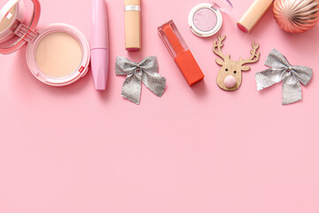 Naklejka premium Composition with decorative cosmetics and Christmas decor on pink background