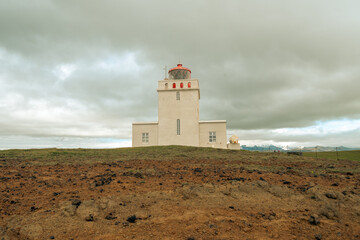 Fototapeta na wymiar Dyrholaey lighthouse, in Iceland on an overcast cloudy day