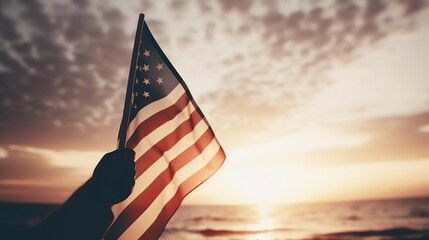 Waving usa flag in hand at sunset - Powered by Adobe