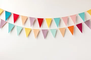 Foto op Plexiglas Colorful holiday flags in the form of a garland on the wall. The garland hangs in two rows. Congratulatory background with place for text. Holiday concept © Vovmar