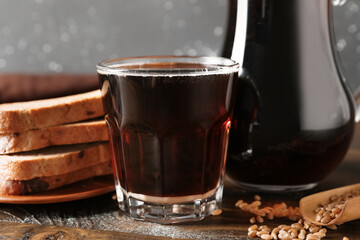 Glass of tasty kvass on table