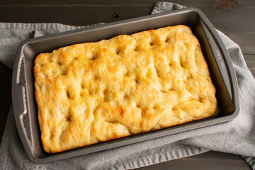 Freshly Baked Focaccia Bread in a Shallow Pan: Freshly baked Italian peasant bread in a metal baking pan