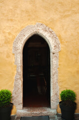 Fototapeta na wymiar Front view, medium distance of, Fai della Paganella cathedral, side entrance, Italy