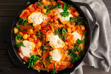Ratatouille Brunch Skillet with Eggs and Spinach: Eggplant, zucchini, bell pepper, and tomato stew in a cast iron skillet
