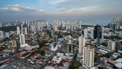 Fototapeta premium Beautiful aerial view of Panama City, its skyscraper buildings, the Cinta Costera at Sunset