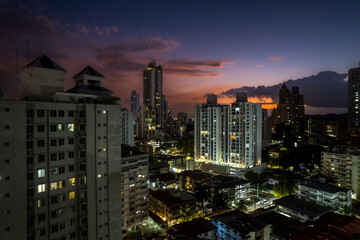 Fototapeta premium Beautiful aerial view of Panama City, its skyscraper buildings, the Cinta Costera at Sunset