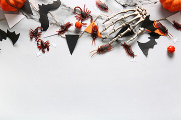 Halloween composition with candy bugs, garland and web on white background