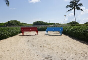 Blue and red color benches in South Miami Beach Lummus park
