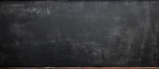 Long horizontal studio with a black background and copy space on a textured blackboard wall