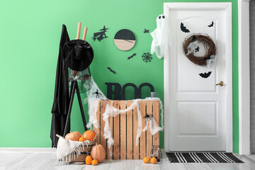 Fototapeta na wymiar Interior of hall decorated for Halloween with door and rack