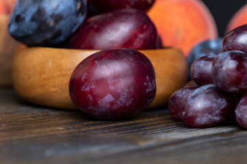 Ripe plums on the table in the kitchen