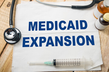 Medicaid expansion, text words typography written on paper, health and medicine
