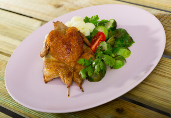 Whole fried quail served with steamed cauliflower and brussel sprouts