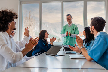 A medical team of doctors support and applause in celebration at the meeting in the office concept...