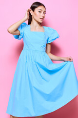 Fototapeta premium happy woman fashion studio young dress beautiful blue model pink style